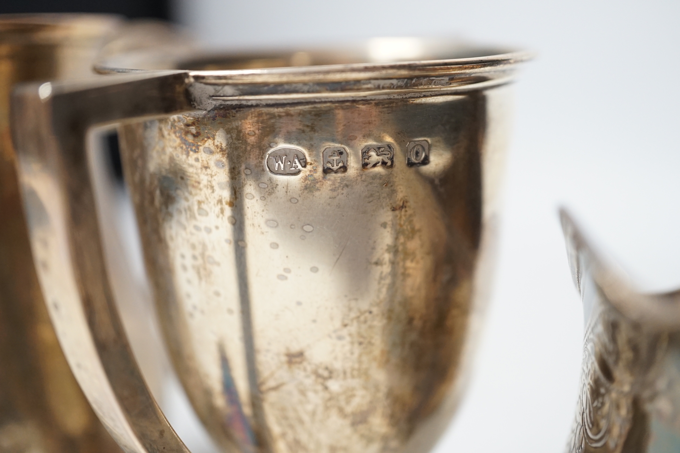 A George III silver cream jug, London, 1806, a George III silver half pint baluster mug, London, 1769 and a later silver two handled trophy cup, 13.7oz.